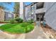 Inviting exterior with lush lawn and a walkway leading to the home's entrance and second story at 6410 S Dayton St # I05, Englewood, CO 80111