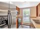 Compact kitchen design features stainless steel appliances, wood cabinets, and ample natural light at 6410 S Dayton St # I05, Englewood, CO 80111