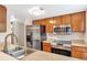 Well-equipped kitchen features stainless steel appliances, wood cabinets, and laminate countertops at 6410 S Dayton St # I05, Englewood, CO 80111
