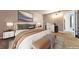 Elegant bedroom with stylish decor, including lamps, console, modern artwork, and a comfortable upholstered bed at 6410 S Dayton St # I05, Englewood, CO 80111