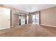 Bedroom featuring mirrored closet doors, neutral carpet, and sliding glass door access to balcony at 6410 S Dayton St # I05, Englewood, CO 80111