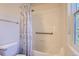 Bathroom featuring a shower and tub combo, accessible grab bar, and a floral curtain at 3752 Red Deer Trl, Broomfield, CO 80020