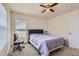 Comfortable bedroom with natural light, neutral carpet, and a ceiling fan with lighting at 3752 Red Deer Trl, Broomfield, CO 80020