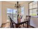 Bright dining room with a chandelier, a table set for four, and sliding glass doors to outdoor patio at 3752 Red Deer Trl, Broomfield, CO 80020
