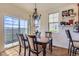 Inviting dining room with a chandelier, a table set for four, and sliding glass doors at 3752 Red Deer Trl, Broomfield, CO 80020