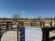View of the fenced dog park showcasing the park rules with ample running space and dog-friendly amenities at 3752 Red Deer Trl, Broomfield, CO 80020