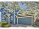 Charming blue two-story home with an attached garage and beautiful flowering trees in the front yard at 3752 Red Deer Trl, Broomfield, CO 80020
