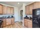 Bright kitchen featuring wood cabinets, stainless steel appliances, and a convenient pantry at 3752 Red Deer Trl, Broomfield, CO 80020