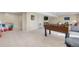 Large basement room with neutral carpet, foosball table, desk, couch and entertainment center at 5997 S Yakima St, Aurora, CO 80015