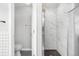 Bathroom with a toilet and walk-in shower featuring marble-style tiling at 5997 S Yakima St, Aurora, CO 80015