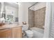 Bathroom featuring wood cabinets, tub, and shower combination at 5997 S Yakima St, Aurora, CO 80015