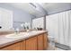 Bright bathroom featuring a double sink vanity and shower with a neutral color palette at 5997 S Yakima St, Aurora, CO 80015