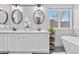 Bathroom with dual sinks, granite counters, and a bright window at 5997 S Yakima St, Aurora, CO 80015