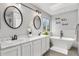 Bright bathroom features dual sinks, garden tub, and modern finishes at 5997 S Yakima St, Aurora, CO 80015