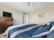 Bedroom featuring a queen bed with blue accents, closet, and dresser at 5997 S Yakima St, Aurora, CO 80015