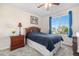 Bedroom with large window, wooden headboard, and natural light at 5997 S Yakima St, Aurora, CO 80015