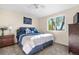 Comfortable bedroom with a large window bringing in natural light and a ceiling fan at 5997 S Yakima St, Aurora, CO 80015