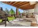 Relaxing covered patio with outdoor seating, a grill, and a hammock in the backyard at 5997 S Yakima St, Aurora, CO 80015