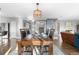 Formal dining room with hardwood floors, large table, and modern chandelier at 5997 S Yakima St, Aurora, CO 80015