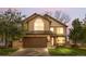 Charming two-story home with a well-manicured lawn and a two-car garage at 5997 S Yakima St, Aurora, CO 80015