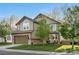 Charming two-story home with a well-manicured lawn, mature tree, and an attached two-car garage at 5997 S Yakima St, Aurora, CO 80015