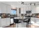 Well-equipped kitchen featuring granite countertops, stainless steel appliances, and barstool seating at the island at 5997 S Yakima St, Aurora, CO 80015