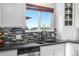 Bright kitchen with granite countertops, updated appliances, tile backsplash, and a large window for natural light at 5997 S Yakima St, Aurora, CO 80015