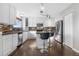 Modern kitchen with stainless steel appliances, granite countertops, stylish tile backsplash, and a central island with bar seating at 5997 S Yakima St, Aurora, CO 80015