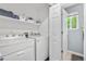Bright laundry room featuring washer, dryer, and storage shelf at 5997 S Yakima St, Aurora, CO 80015