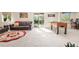 Open living area with sliding door to backyard, couch, chairs, bar stools, and foosball table at 5997 S Yakima St, Aurora, CO 80015
