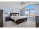 Bright main bedroom featuring vaulted ceilings, large windows, and dark wood furniture at 5997 S Yakima St, Aurora, CO 80015