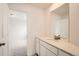 Bright bathroom with large mirror, white cabinets, and solid surface countertop at 39460 Congress Ln, Elizabeth, CO 80107