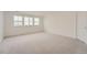 Neutral bedroom with wall-to-wall carpet and natural light from the large windows at 39460 Congress Ln, Elizabeth, CO 80107