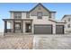 Charming two-story home with a covered porch, gray trim and a two-car garage at 39460 Congress Ln, Elizabeth, CO 80107