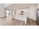 Modern kitchen featuring a large island, stainless steel appliances, and sliding glass doors to the backyard at 39460 Congress Ln, Elizabeth, CO 80107