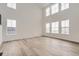 Spacious living room featuring wood floors, high ceilings, and lots of natural light from large windows at 39460 Congress Ln, Elizabeth, CO 80107