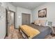 Bedroom featuring a gray bed, closet, and modern decor at 4021 S Teller St, Lakewood, CO 80235