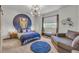 Stylish bedroom with a blue accent wall, modern lighting, and cozy seating area at 4021 S Teller St, Lakewood, CO 80235