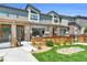 Beautiful exterior view of a modern townhouse with brick pillars, wooden fence, and a well-maintained lawn at 4021 S Teller St, Lakewood, CO 80235