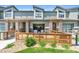 Charming townhouse featuring a cozy front patio and modern architectural details at 4021 S Teller St, Lakewood, CO 80235