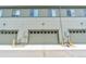 View of the front garages of an apartment building, with each entrance marked by a different address number at 4021 S Teller St, Lakewood, CO 80235