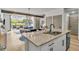 Open-concept kitchen and living area featuring a spacious island at 4021 S Teller St, Lakewood, CO 80235