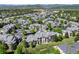 An aerial view showcases a community of residential buildings with lush green trees surrounding them at 7422 S Quail Cir # 1624, Littleton, CO 80127