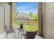Comfortable balcony with view of backyard, string lights, and table with chairs at 7422 S Quail Cir # 1624, Littleton, CO 80127