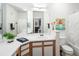 Bright bathroom featuring a large mirror, white countertop, and stylish wood-trimmed cabinets at 7422 S Quail Cir # 1624, Littleton, CO 80127