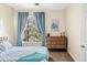 Comfortable bedroom with dresser and a bright window at 7422 S Quail Cir # 1624, Littleton, CO 80127