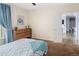Comfortable bedroom with dresser and open doorway to the hall at 7422 S Quail Cir # 1624, Littleton, CO 80127