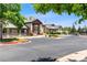 Clubhouse exterior featuring stone accents, mature landscaping, and convenient parking at 7422 S Quail Cir # 1624, Littleton, CO 80127