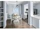 Charming dining area with white table, chairs, and modern light fixture, adjacent to kitchen at 7422 S Quail Cir # 1624, Littleton, CO 80127