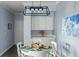 Charming dining space with modern lighting and seamless flow into the kitchen at 7422 S Quail Cir # 1624, Littleton, CO 80127
